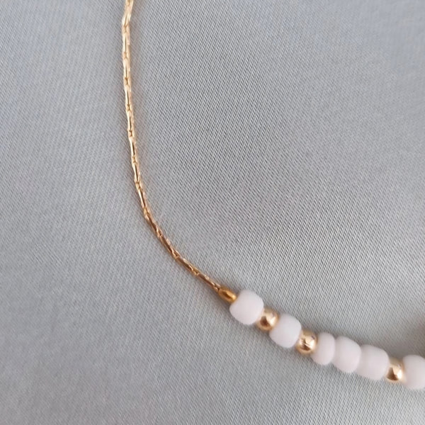 Bracelet fantaisie perles blanches et dorées œil