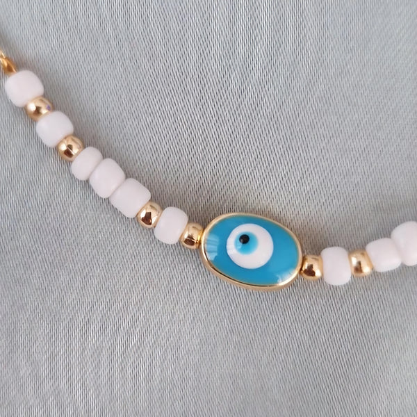 Bracelet fantaisie perles blanches et dorées œil