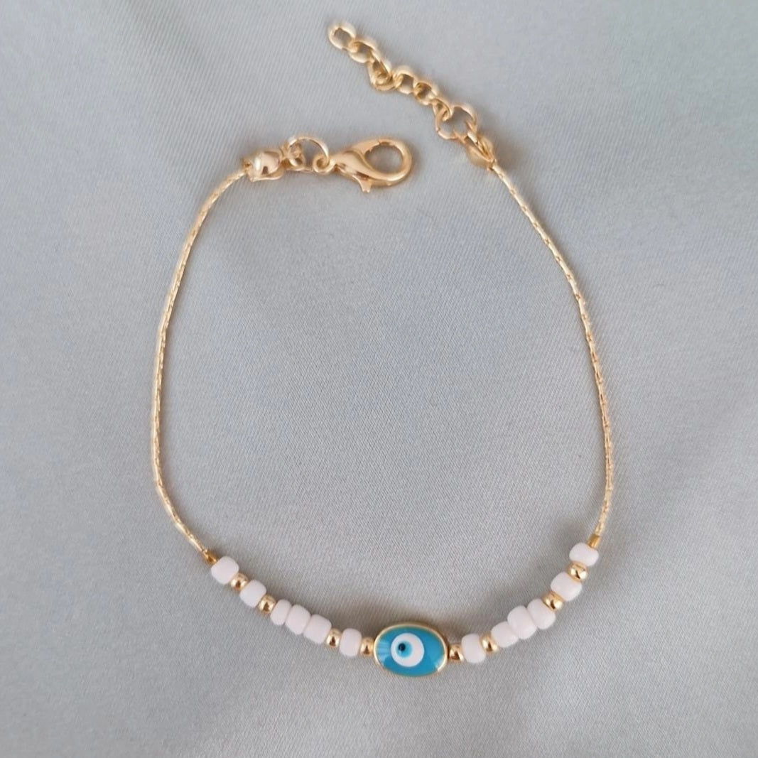 Bracelet fantaisie perles blanches et dorées œil